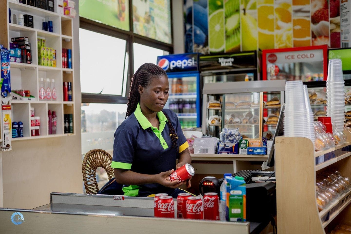 A worker at the counter, focused mid-sale